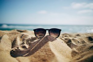 sun glasses on sandy beach