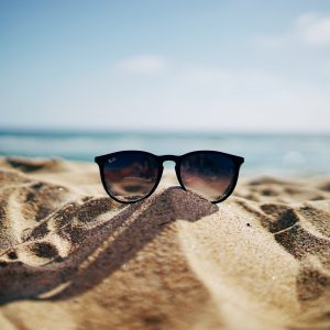 sun glasses on sandy beach