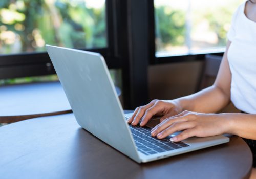 woman typing on a laptop